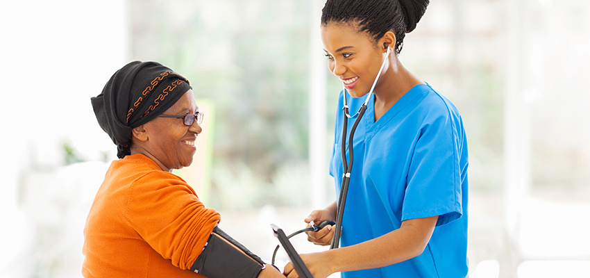 Nursing student taking blood pressure of patient.