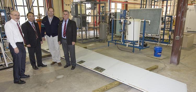 The donation of an A330 elevator from Airbus to the University of South Alabama will make "possible for our engineering students to study and test a very large commercial version of the high-strength materials that are the subject of their classes and laboratory experiments," said Dr. John Steadman, dean of the College of Engineering. Standing with the elevator, from left, are Steadman; David Trent, Airbus Mobile Engineering Center site director; Dr. Kuang-Ting Hsiao, USA mechanical engineering professor; and David Nelson, chair of mechanical engineering. 