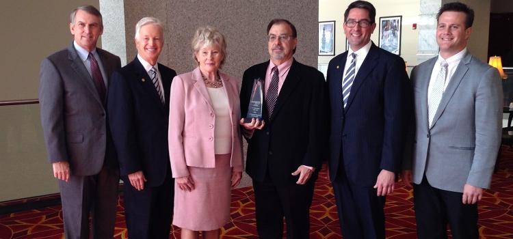 USA's Coastal Innovation Hub received the 2014 Innovator of the Year Award from the Mobile Area Chamber of Commerce on Friday, Nov. 21, 2014. From left, are Dr. Andrew Byrd, marketing and licensing associate with USA's Office of Intellectual Property Management; Chamber President Bill Sisson; Dr. Mark Weaver, director of the Coastal Innovation Hub; Lynne Chronister , USA vice president for research and economic development; Michael Chambers, Chamber chairman of the board; and Ker Ferguson, USA assistant vice president for research and economic development. 